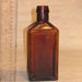 Antique brown bottle glass art repaired by Michael Bokrosh